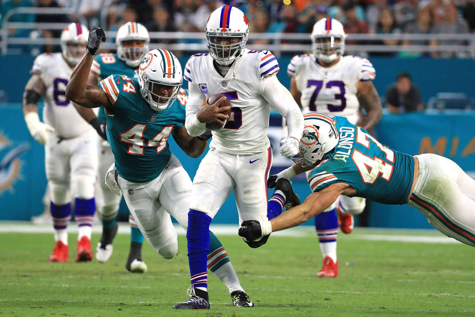 MIAMI GARDENS, FL - DECEMBER 31: Stephone Anthony #44 of the Miami Dolphins forces a fumble on Tyrod Taylor #5 of the Buffalo Bills during the second quarter against the Miami Dolphins at Hard Rock Stadium on December 31, 2017 in Miami Gardens, Florida.  (Photo by Mike Ehrmann/Getty Images)