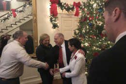 Gov. Larry Hogan and his wife Yumi greets guests at the Governor's Mansion at the annual holiday open house. (WTOP/Dick Uliano)