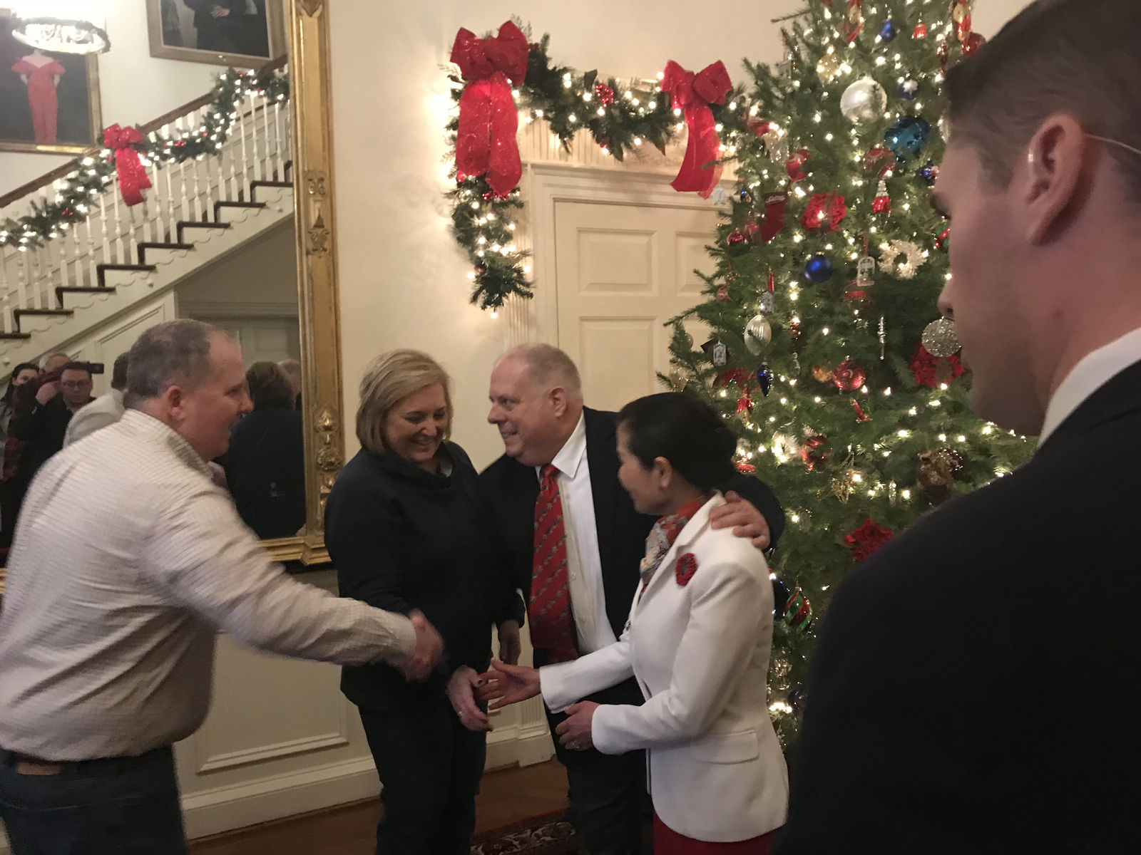 Gov. Larry Hogan and his wife Yumi greets guests at the Governor's Mansion at the annual holiday open house. (WTOP/Dick Uliano)