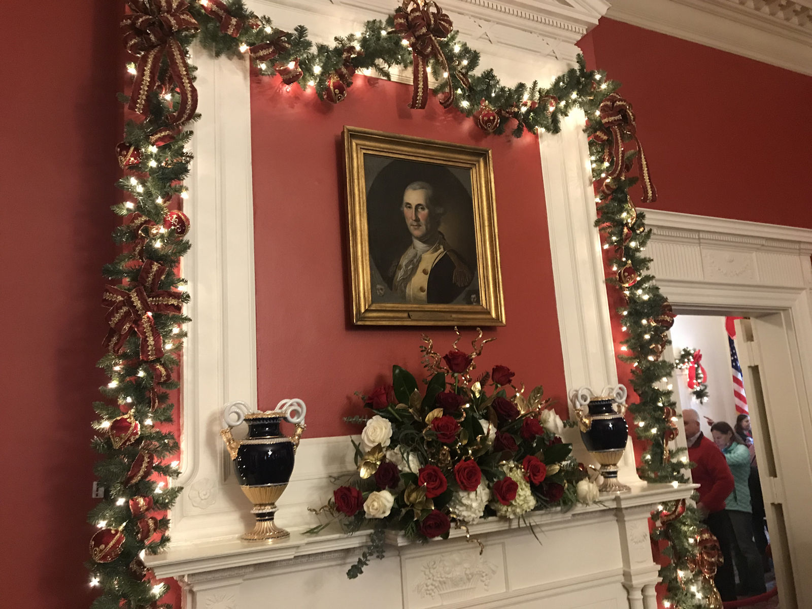 Fresh garland hung over doorways and framed the painting of George Washington by Charles Wison Peale, which hangs above one of the fireplaces in the drawing room. (WTOP/Dick Uliano)