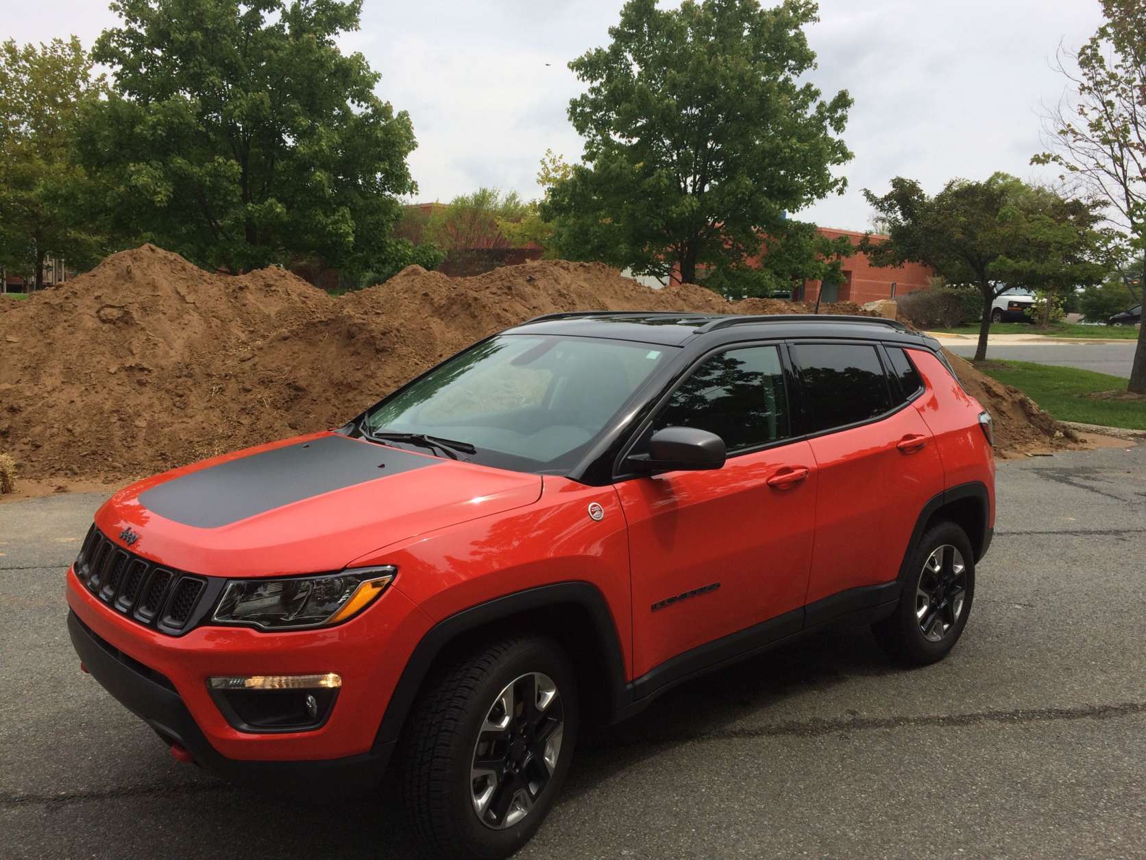 The Jeep rides higher than most small crossovers. There is a black roof and dual hood color that looks nice with the Spitfire orange color. Red tow hooks front and back add to the off road cred.(WTOP/Mike Parris)