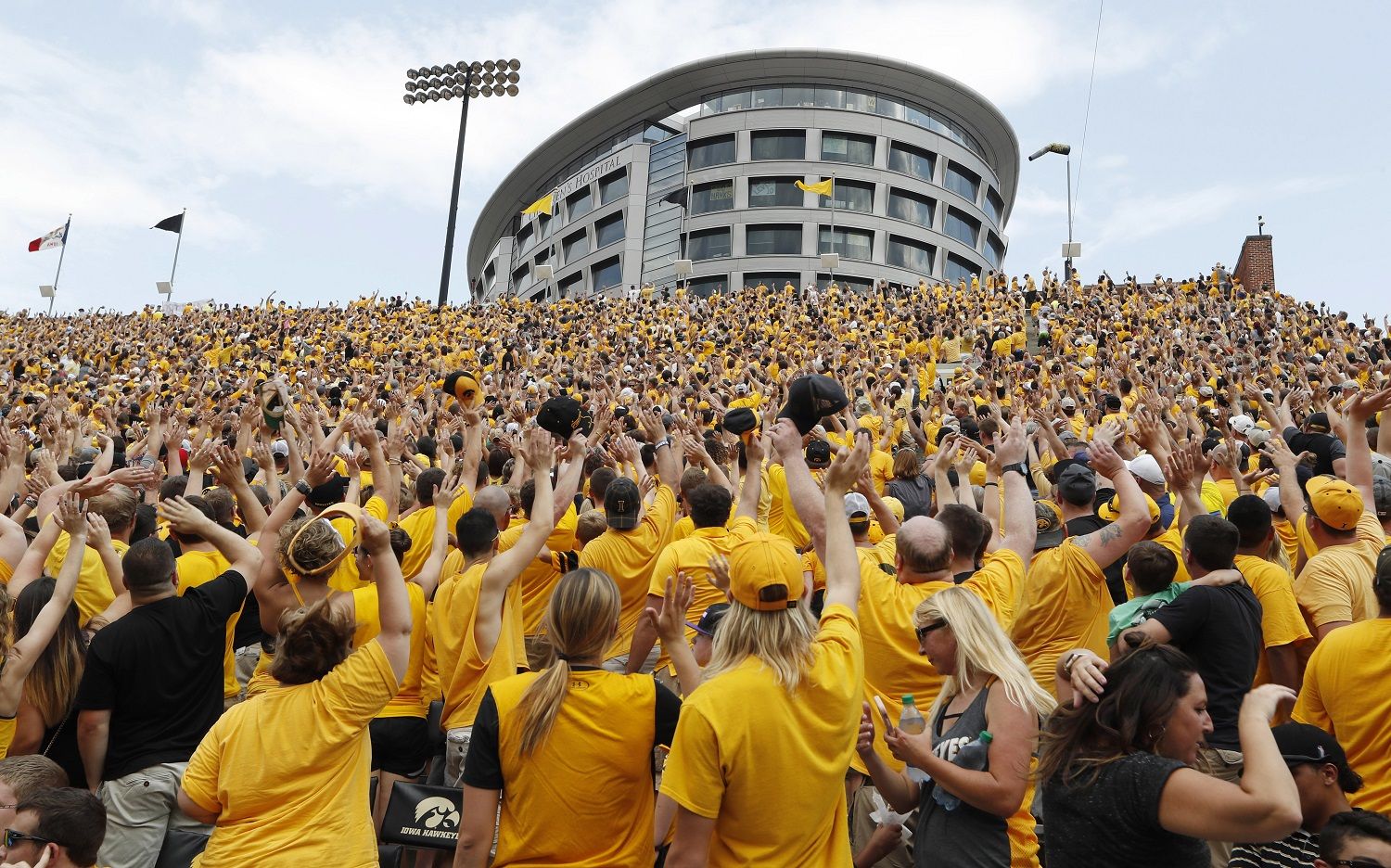 Iowa fans wave to children in the University of Iowa Stead Family Children's Hospital at the end of the first quarter of an NCAA college football game against North Texas, Saturday, Sept. 16, 2017, in Iowa City, Iowa. (AP Photo/Charlie Neibergall)