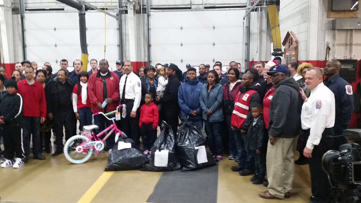 At the Silver Hill Fire Station in Suitland, Maryland, the Prince George’s County Fire Department, the American Red Cross, Toys for Tots and Fire Chiefs Community Advisory Council provided gift cards, bicycles and trash bags full of toys to the 21 adults and 12 children affected by the apartment fire. (WTOP/Kathy Stewart)