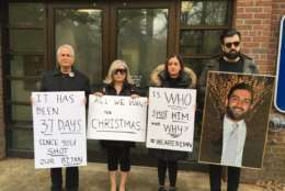 Ghaisar’s mom, dad, sister and brother-in-law gathered outside U.S. Park Police District Two Station, just off of the George Washington Parkway Sunday. They held signs and a large, framed photo of Bijan—and were looking for answers. (WTOP/Liz Anderson) 