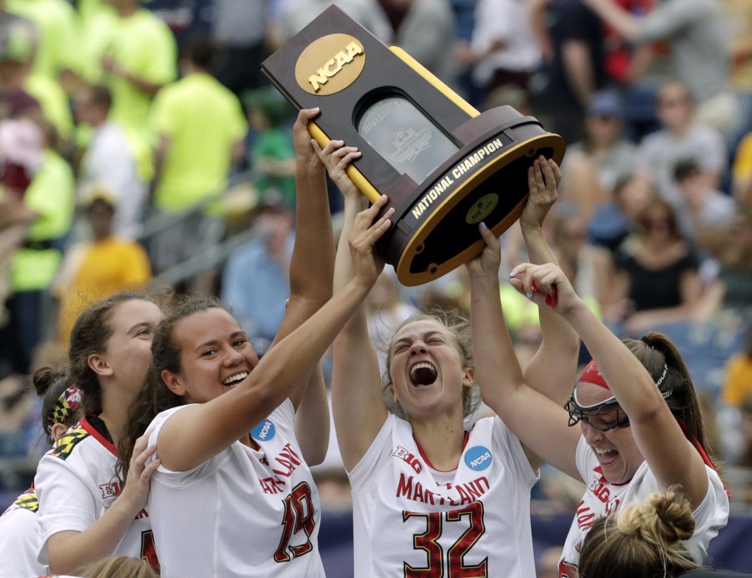 Maryland's Alex McKay (19), Bairre Reilly (32) and Meghan Doherty, far right, celebrate with the trophy after they defeated Boston College to win the NCAA college Division 1 lacrosse championship final, Sunday, May 28, 2017, in Foxborough, Mass. (AP Photo/Elise Amendola)