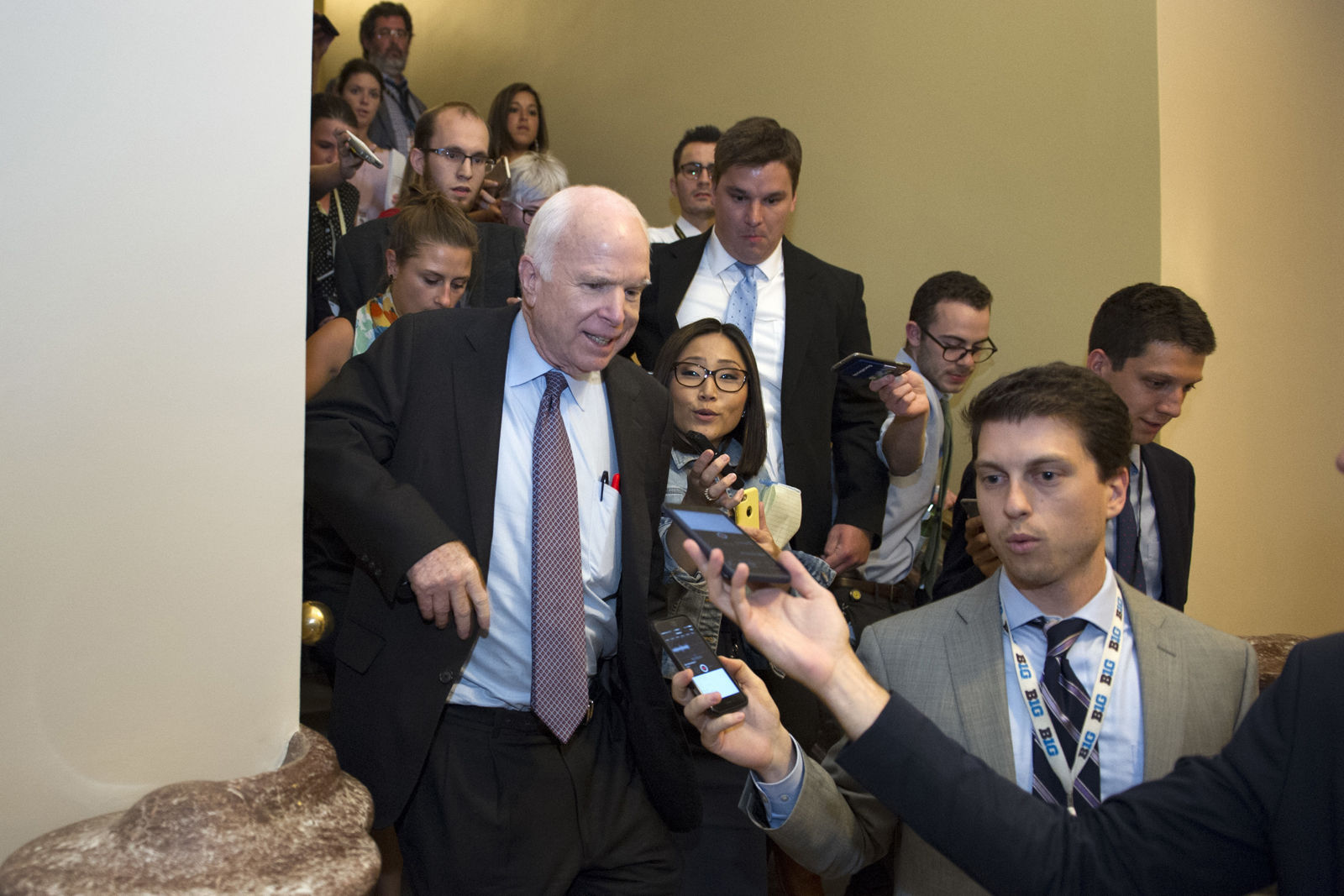 FILE - In this July 28, 2017, file photo, Sen. John McCain, R-Az., front left, is is followed by reporters after casting a 'no' vote on a a measure to repeal parts of former President Barack Obama's health care law, on Capitol Hill in Washington. Longtime friends and advisers of Sen. John McCain said they were not surprised by his decision in September to oppose a last-ditch Republican effort to overhaul the national health care law. McCain objected to the legislation in part because Senate GOP leaders wanted a vote without holding hearings or debate. (AP Photo/Cliff Owen, File)