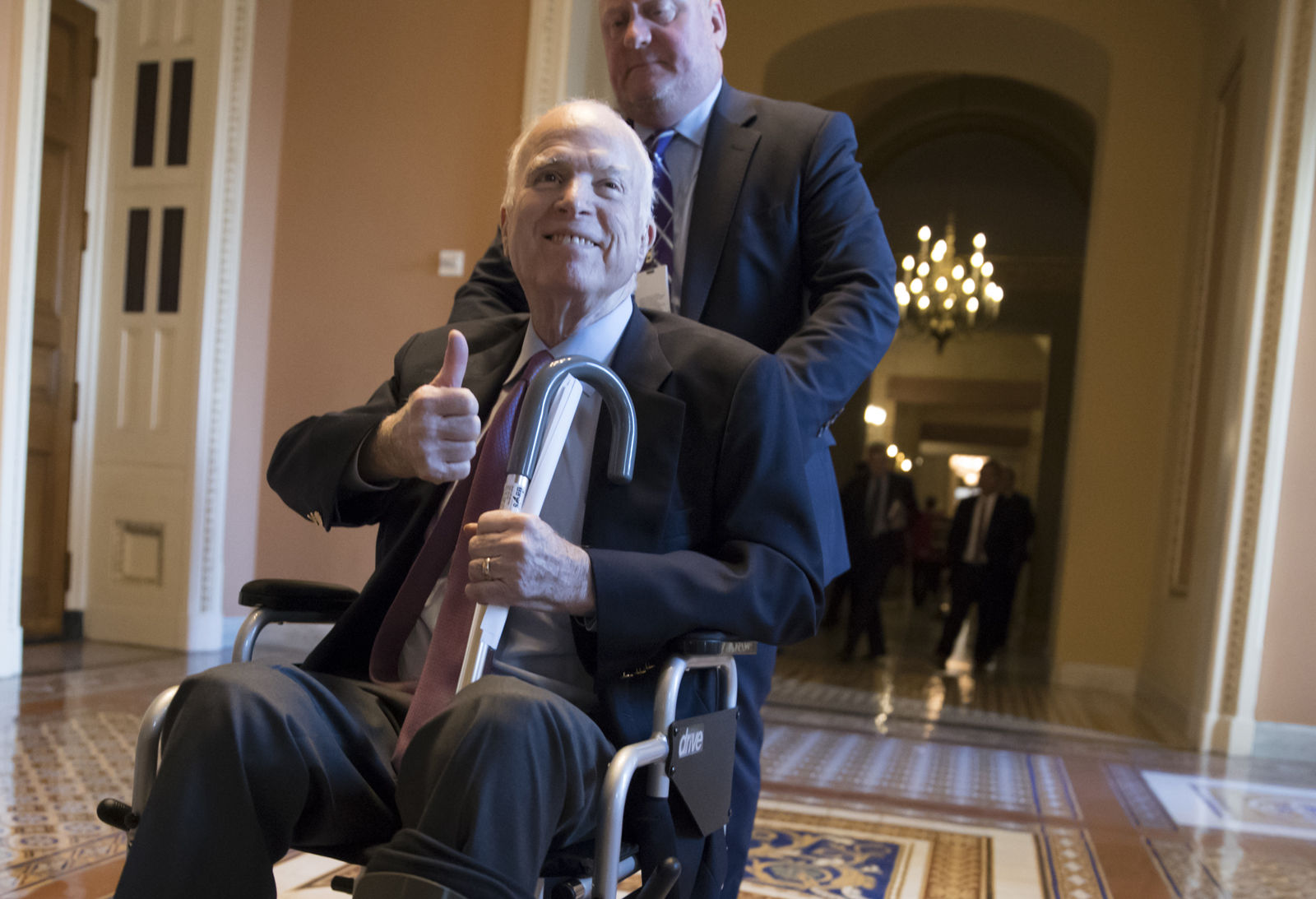 Sen. John McCain leaving a closed-door session with Republican senators on Dec. 1, 2017. McCain was hospitalized for side effects from his brain cancer treatment in December and announced he would miss the Senate vote on the Republican tax bill to spend the holidays at home in Arizona with his family. (AP Photo/J. Scott Applewhite, File)