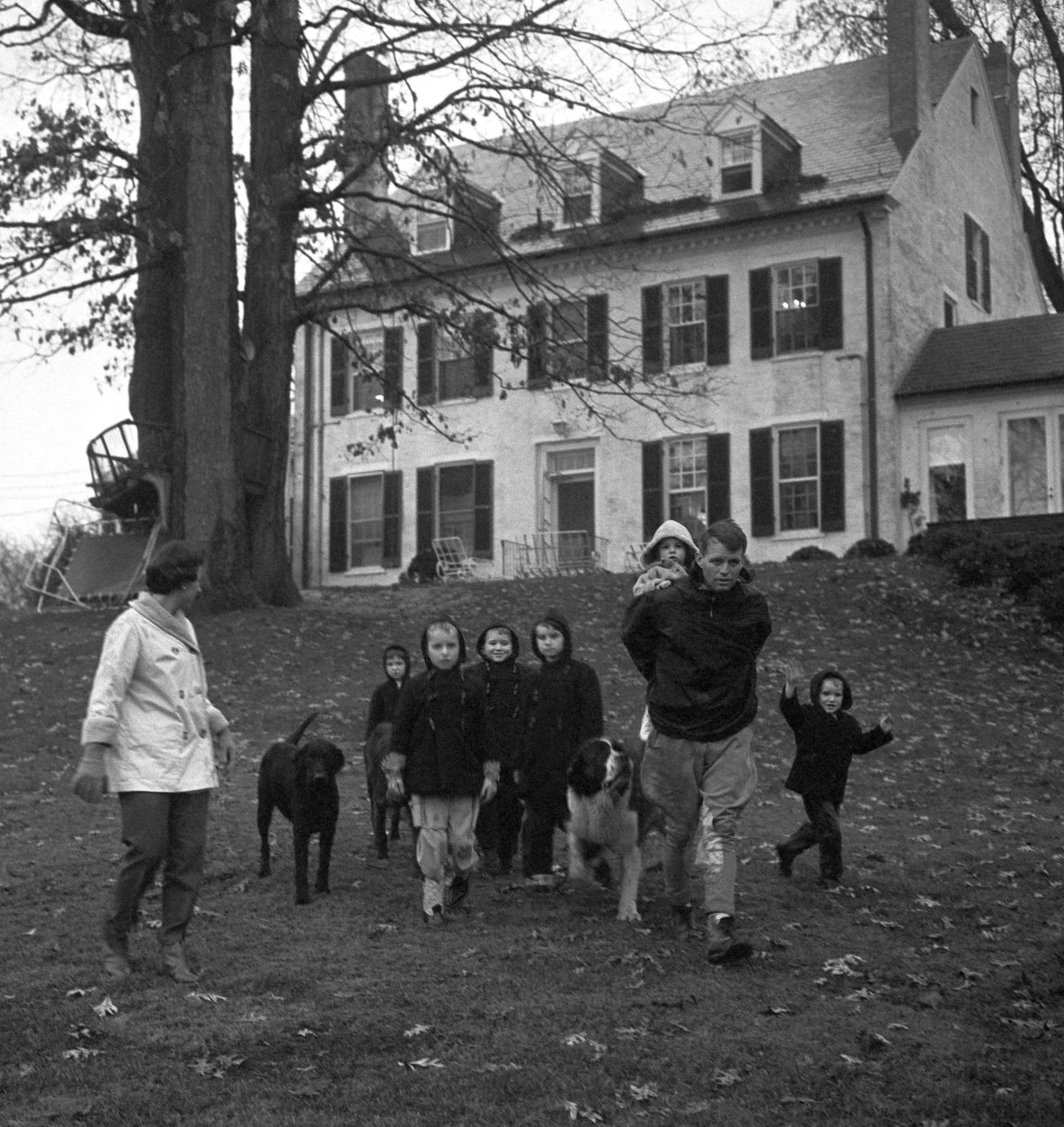The Robert Kennedy family takes a walk at the Kennedy home in McLean, Va., on Dec. 30, 1959. From left: Mrs. Ethel Kennedy; Courtney, 3; Kathleen, 8; Joseph Patrick, 7; Robert Kennedy with one and a half-year-old Michael on his back; Bobby, 5; and David, 4. (AP Photo/Henry Griffin)