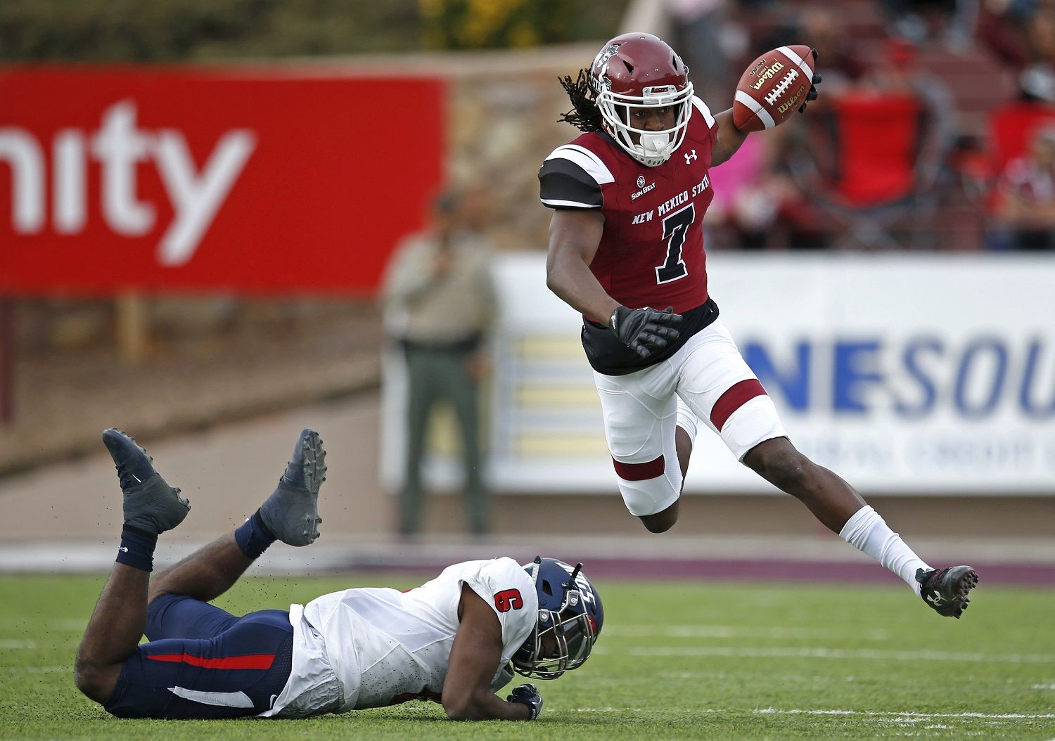 New Mexico State wide receiver Gregory Hogan (7) avoids the tackle attempt by South Alabama safety Nigel Lawrence (6) during the first half of an NCAA college football game in Las Cruces, N.M., Saturday, Dec. 2, 2017. (AP Photo/Andres Leighton)