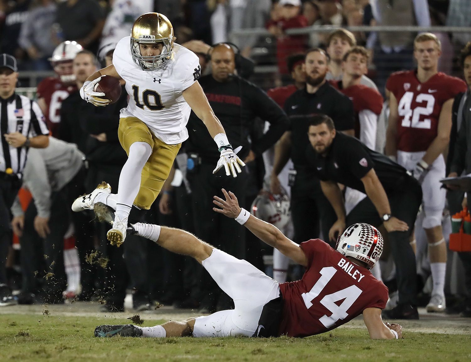 Notre Dame's Chris Finke (10) leaps over Stanford punter Jake Bailey (14) on a punt return during the second half of an NCAA college football game Saturday, Nov. 25, 2017, in Stanford, Calif. Stanford won 38-20. (AP Photo/Tony Avelar)