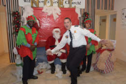 D.C. Police Chief Peter Newsham goofs around while taking a picture with Santa at Faith Moravian Church before shopping began at the Walmart across the street on Wednesday, Dec. 6, 2017. (Courtesy Tony Brown)