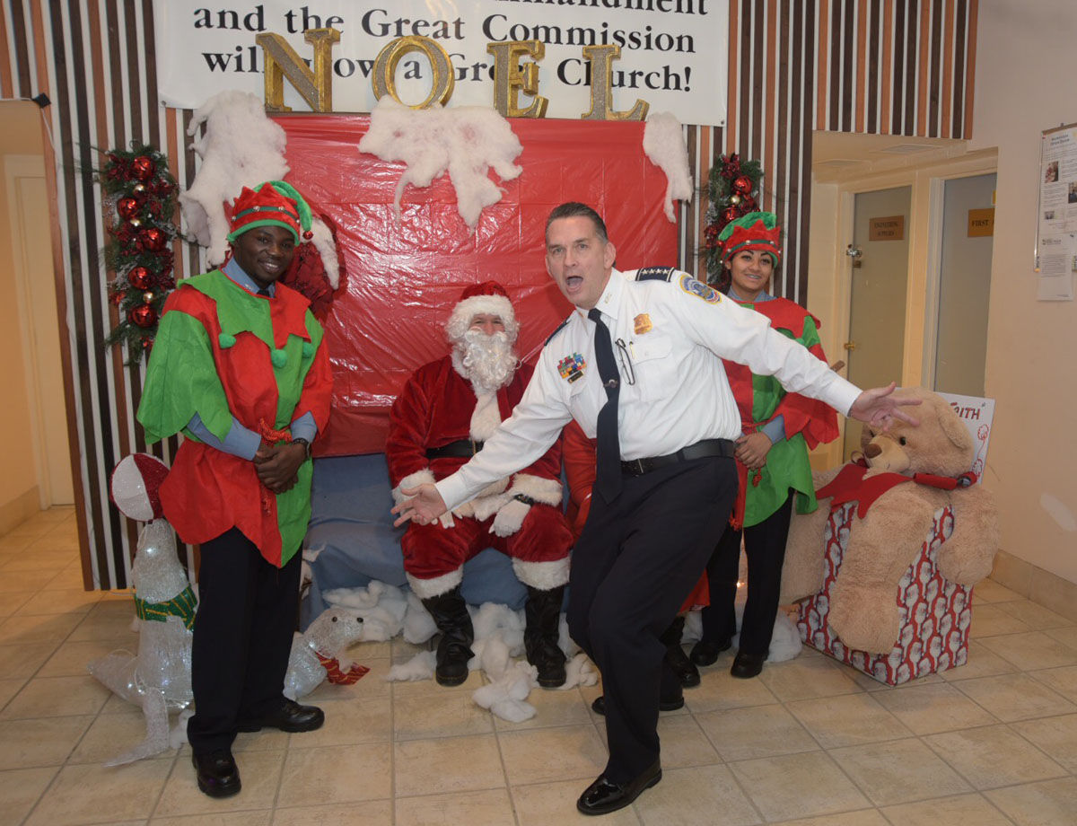 D.C. Police Chief Peter Newsham goofs around while taking a picture with Santa at Faith Moravian Church before shopping began at the Walmart across the street on Wednesday, Dec. 6, 2017. (Courtesy Tony Brown)