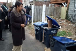 D.C. Mayor Muriel Bowser looks at some of trash that is improperly stored in the District. Improperly stored trash is one of the biggest contributor's to D.C.'s rat problem. (Courtesy Larry Janezich)