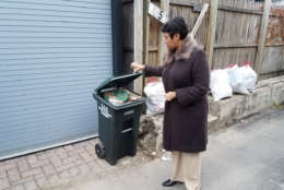 D.C. Mayor Muriel Bowser looks at a trash can in the District. (Courtesy Larry Janezich)