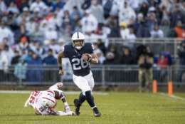 UNIVERSITY PARK, PA - NOVEMBER 18:  Saquon Barkley #26 of the Penn State Nittany Lions slips by Kieron Williams #26 of the Nebraska Cornhuskers during a touchdown run during the first quarter on November 18, 2017 at Beaver Stadium in University Park, Pennsylvania.  (Photo by Brett Carlsen/Getty Images)