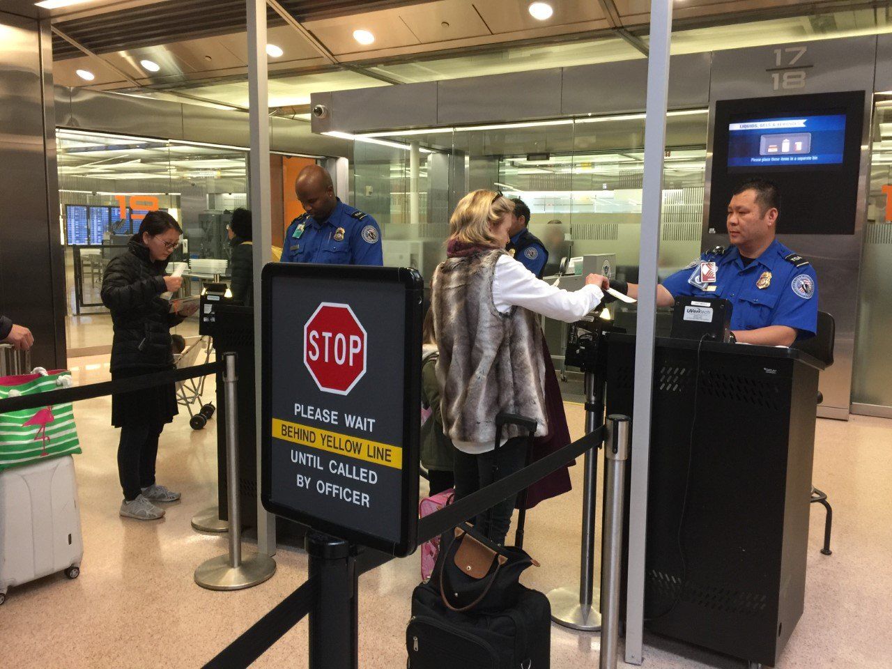 New this year at TSA checkpoints: All personal electronics bigger than a phone have to be taken out of your bags and put in a separate bin. (WTOP/Kristi King)