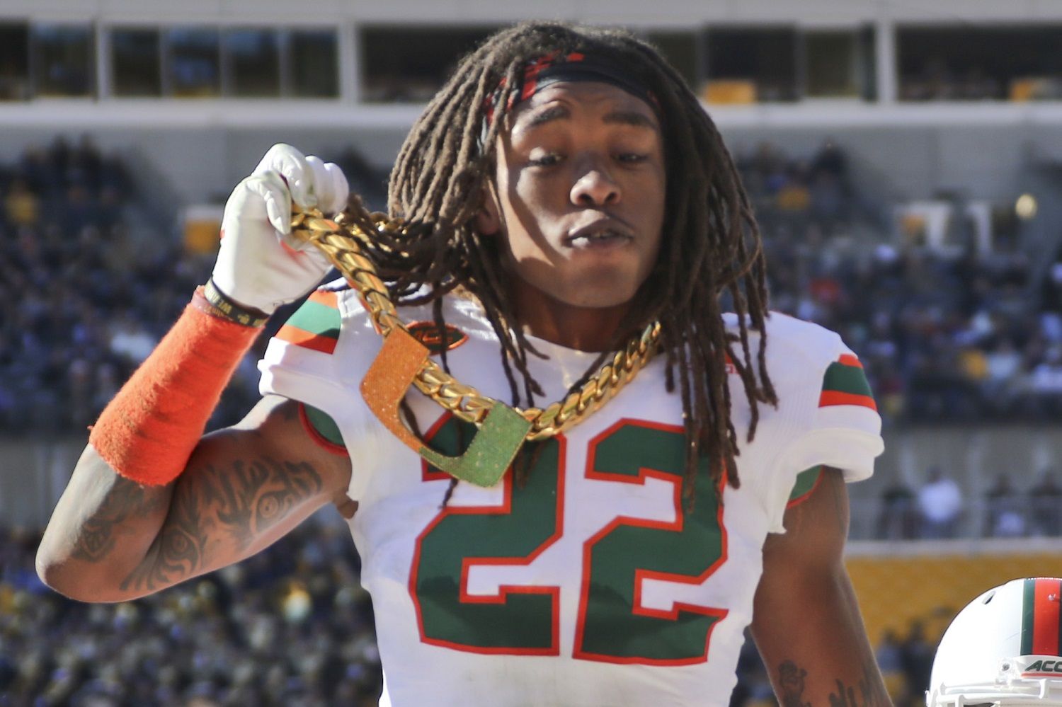 Miami defensive back Sheldrick Redwine (22) shows off their "U" turnover chain after recovering a fumble against Pittsburgh in an NCAA college football game, Friday, Nov. 24, 2017, in Pittsburgh. (AP Photo/Keith Srakocic)