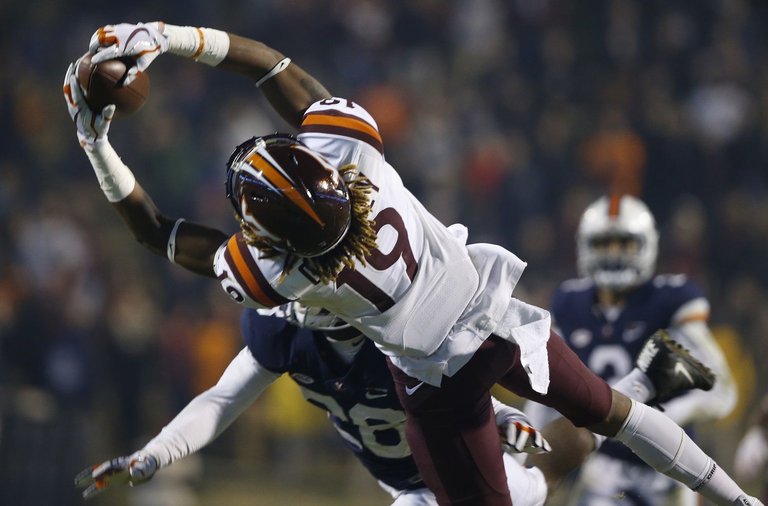 Virginia Tech tight end Drake Deiuliis (9) hauls in a pass in front of Virginia safety Brenton Nelson (28) during the second half of an NCAA college football game in Charlottesville, Va., Friday, Nov. 24, 2017. (AP Photo/Steve Helber)