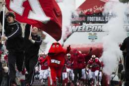 Western Kentucky mascot Big Red leads the team out on the field before the Conference USA championship NCAA college football game against  Louisiana Tech, Saturday, Dec. 3, 2016, at L.T. Smith Stadium in Bowling Green, Ky. (AP Photo/Michael Noble Jr.)