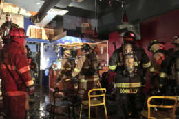 Firefighters examine the building that caught on fire in Adams Morgan Friday, Dec. 22, 2017. (Courtesy D.C. Fire and EMS)