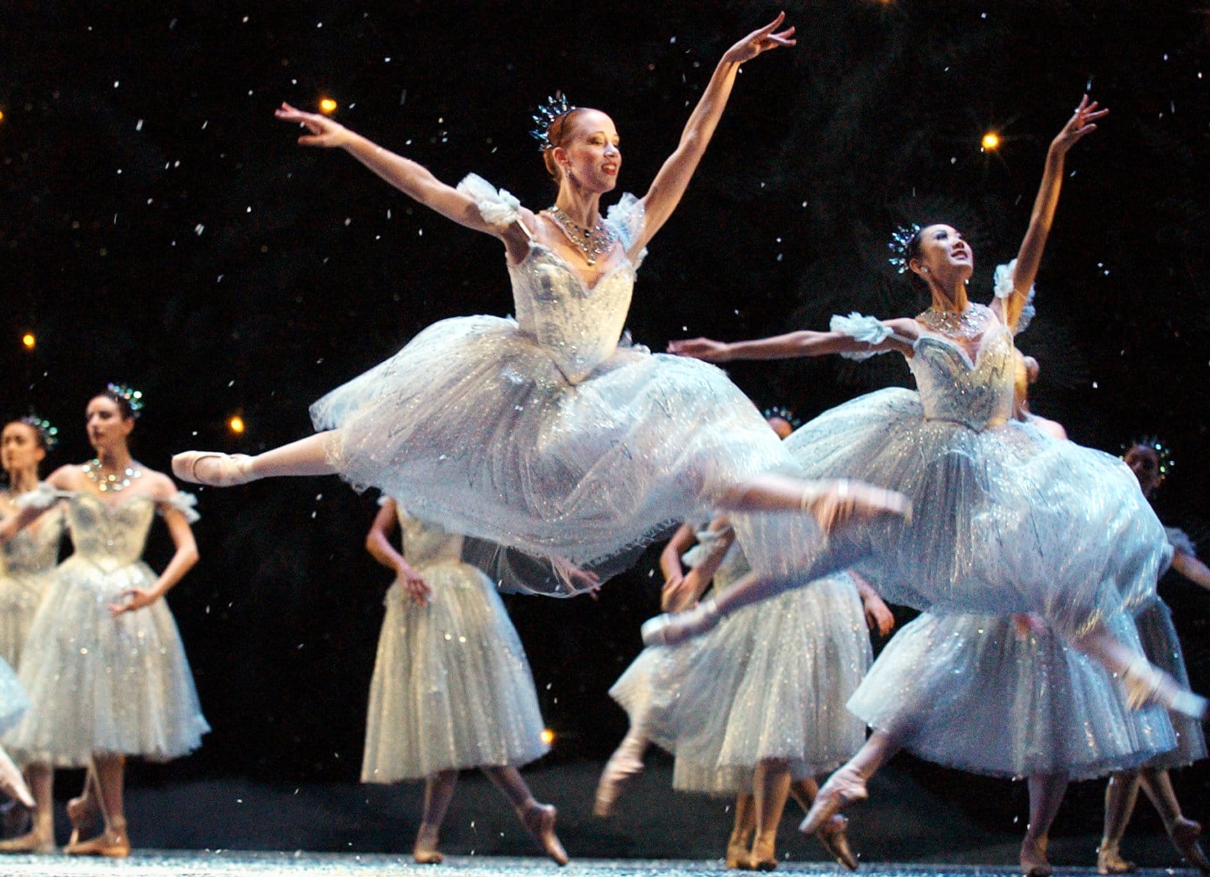 Kristin Ottestad, center, a corps de ballet dancer with the Boston Ballet, performs a leap with other members of the corps during a dress rehearsal of the company's production of The Nutcracker, in Boston, Friday, Nov. 28, 2003. The Nutcracker is to begin Friday evening, Nov. 28, 2003 and run through Tuesday, Dec. 30, 2003. (AP Photo/Steven Senne)