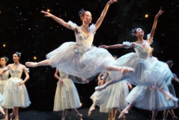 Kristin Ottestad, center, a corps de ballet dancer with the Boston Ballet, performs a leap with other members of the corps during a dress rehearsal of the company's production of The Nutcracker, in Boston, Friday, Nov. 28, 2003. The Nutcracker is to begin Friday evening, Nov. 28, 2003 and run through Tuesday, Dec. 30, 2003. (AP Photo/Steven Senne)