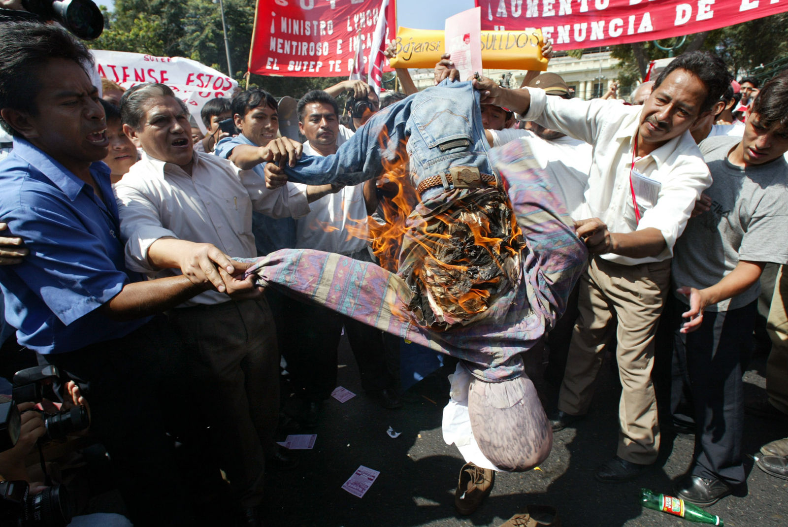 Peruvian teachers protest against President Alejandro Toledo, burning a dummy depicting the Education Minister Nicolas Lynch in front of the Congress building in Lima on Tuesday, May 14, 2002. Several unions and regional civic groups called a day of national protest and strikes against the government, the first under President Alejandro Toledo's nine-month government. Marches in Lima began peacefully, while traffic flowed freely and there were no major disturbances in the capital. (AP Photo/Silvia Izquierdo)