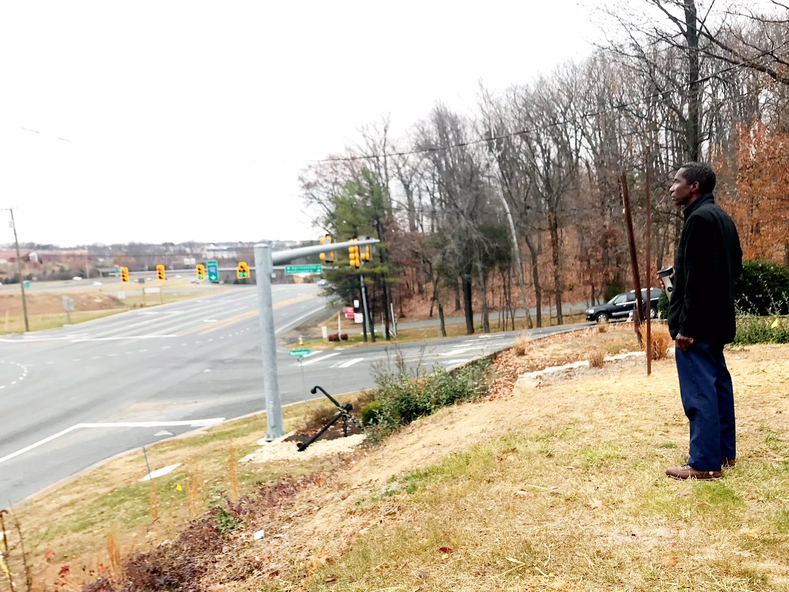 In Dec. 2017, Derrick Butler watched as D.C. police searched near I-95 in Stafford County for the remains of his sister, Pamela, who was murdered in 2009. (WTOP/Neal Augenstein)