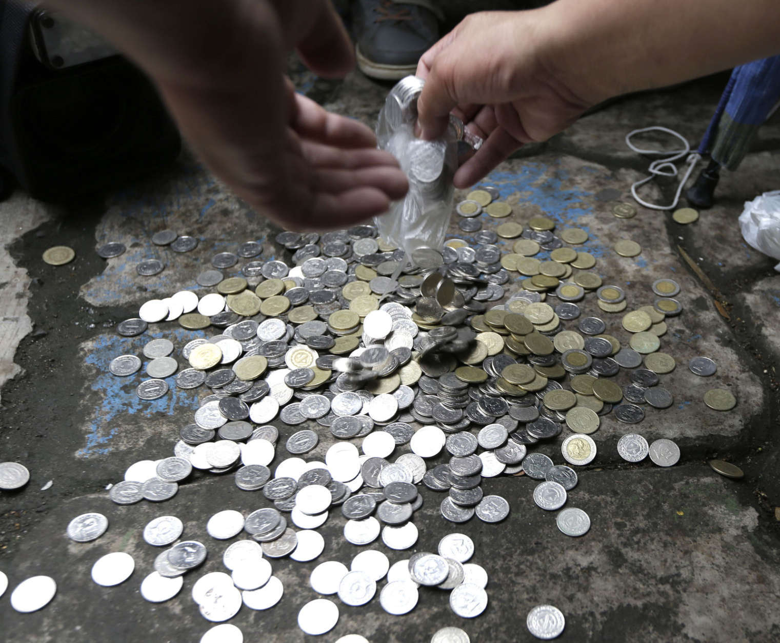 Filipino Muslims collect coins to raise funds as docketing fee for their petition before the Supreme Court in Manila, Philippine,s Monday Sept. 24, 2012 to ban from YouTube the American-produced film "Innocence of Muslims,” that ridicules Islam's Prophet Muhammad, in the Philippines. The low-budget film has angered Muslims in most parts of the world with protests turning violent and resulting in the deaths to dozens of people. (AP Photo/Bullit Marquez)