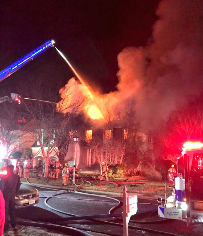 Montgomery County firefighters battle a fire in a two-story house on Larkmeade Lane in Potomac, Maryland, Saturday, Dec. 30, 2017.
(Courtesy Montgomery County Fire & Rescue)
