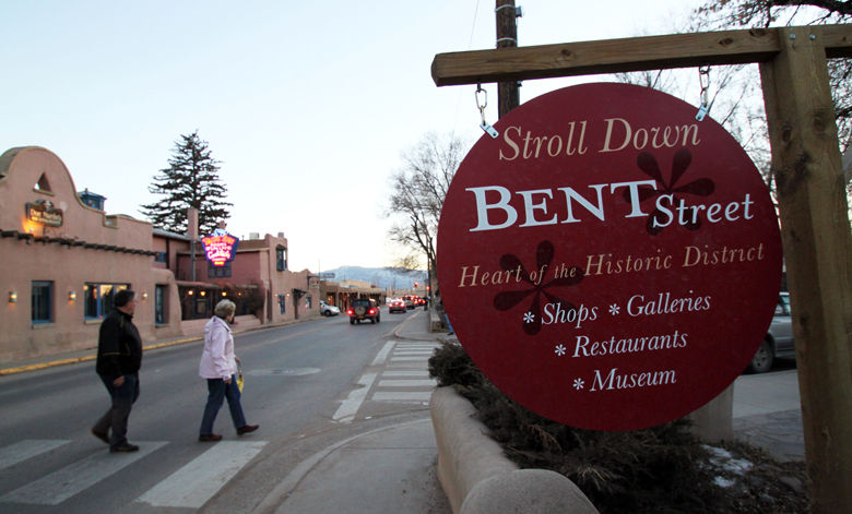 This Feb. 25, 2012 image shows visitors walking toward Bent Street, named after Taos businessman Charles Bent, who was appointed as the civil governor of New Mexico in the late 1840s. Bent's wife, Maria Ignacia Jaramillo, is among the women being recognized by Taos, N.M., as part of its yearlong Remarkable Women celebration. (AP Photo/Susan Montoya Bryan)