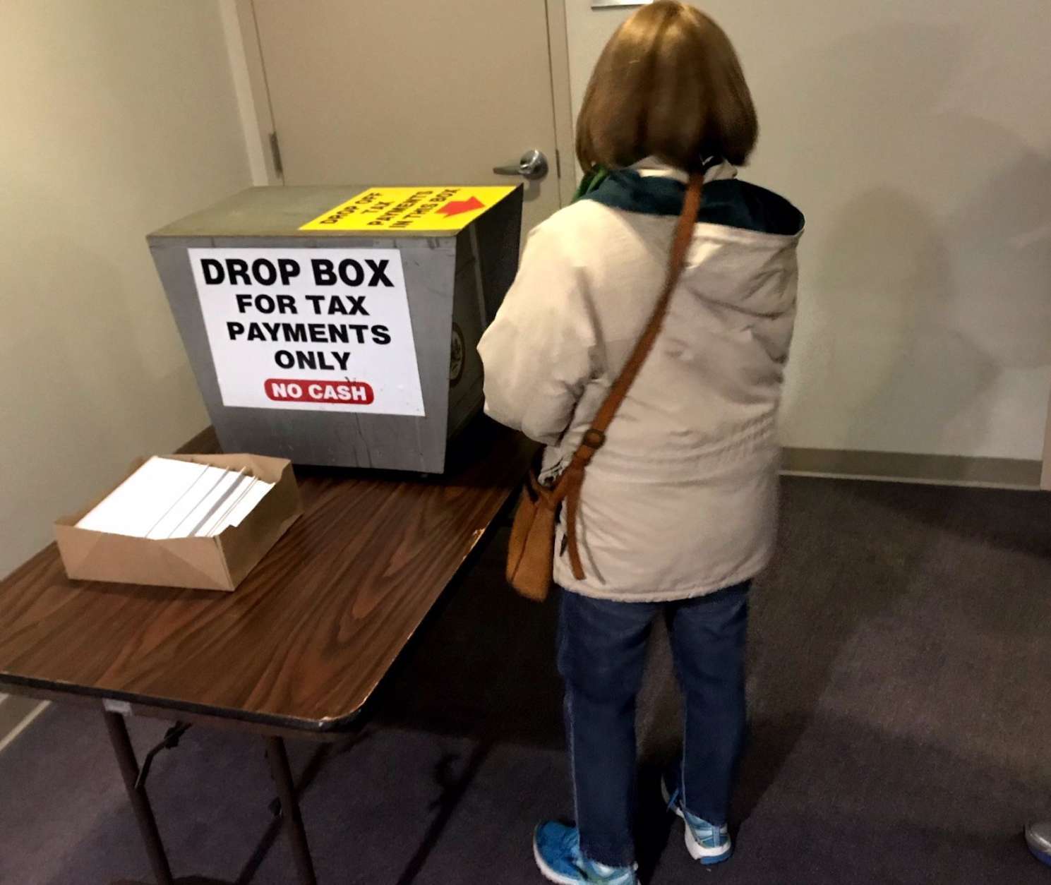 Interest is high in prepaying county property tax,
 ahead of a new tax law. Taxpayers in Fairfax Co. can drop off a check in the county government building.
 (WTOP/Neal Augenstein)