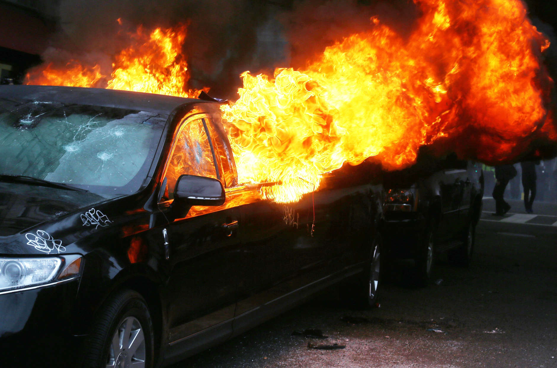 WASHINGTON, DC - JANUARY 20:  A limousine burns after being destroyed by anti-Trump protesters on K Street on January 20, 2017 in Washington, DC. President-elect Donald Trump was sworn-in as the 45th U.S. President today.  (Photo by Mario Tama/Getty Images)