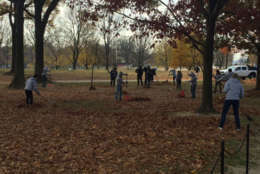 Some volunteers raked leaves near the memorial. (WTOP/John Domen)
