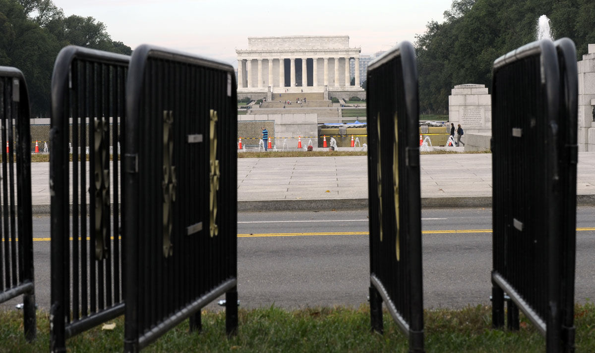 The Lincoln Memorial is framed by barricades near the World War II Memorial in Washington, Thursday, Oct. 17, 2013. Barriers went down at National Park Service sites and thousands of furloughed federal workers began returning to work throughout the country Thursday after 16 days off the job because of the partial government shutdown.(AP Photo/Susan Walsh)