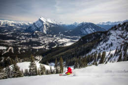 This undated photo provided by Mount Norquay shows a snowboarder on the mountain in the Canadian Rockies, just 15 minutes from the town of Banff, Alberta. Its one of a number of small resorts located near larger, big-name resorts. While the small places dont have as much terrain, they have shorter lines, lower costs and a more relaxed atmosphere. (AP Photo/Mount Norquay, Paul Zizka)