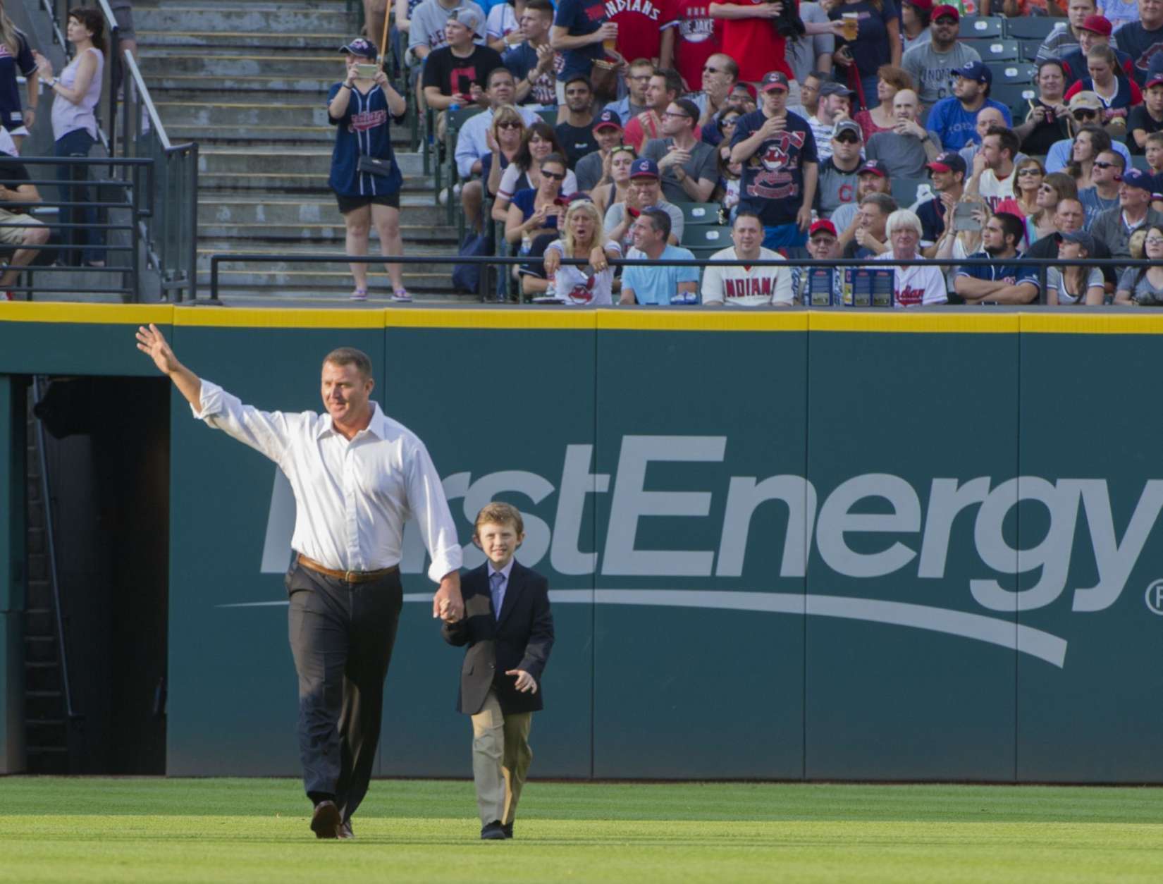 Former Cleveland Indians great Jim Thome walks to his Indians Hall of Fame ceremony with his son Landon, before a baseball game against the Oakland Athletics in Cleveland, Saturday, July 30, 2016. (AP Photo/Phil Long)
