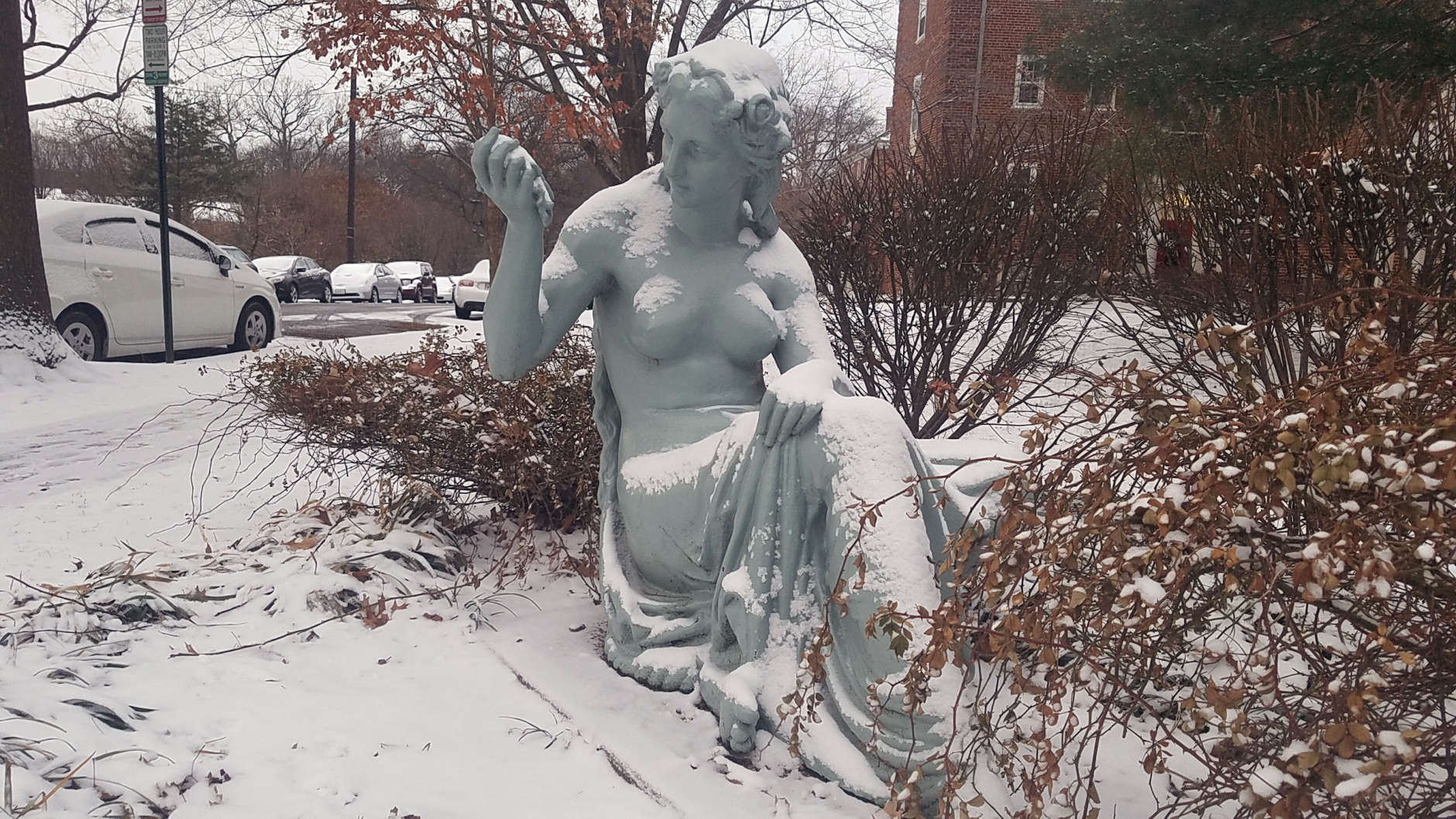 Snow sits on a statue in Northwest D.C. (WTOP/William Vitka)