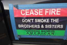 A sign at the MLK Peace Walk and Parade which states, "Cease fire: Don't smoke the Brothers and Sisters." (WTOP/Kristi King)