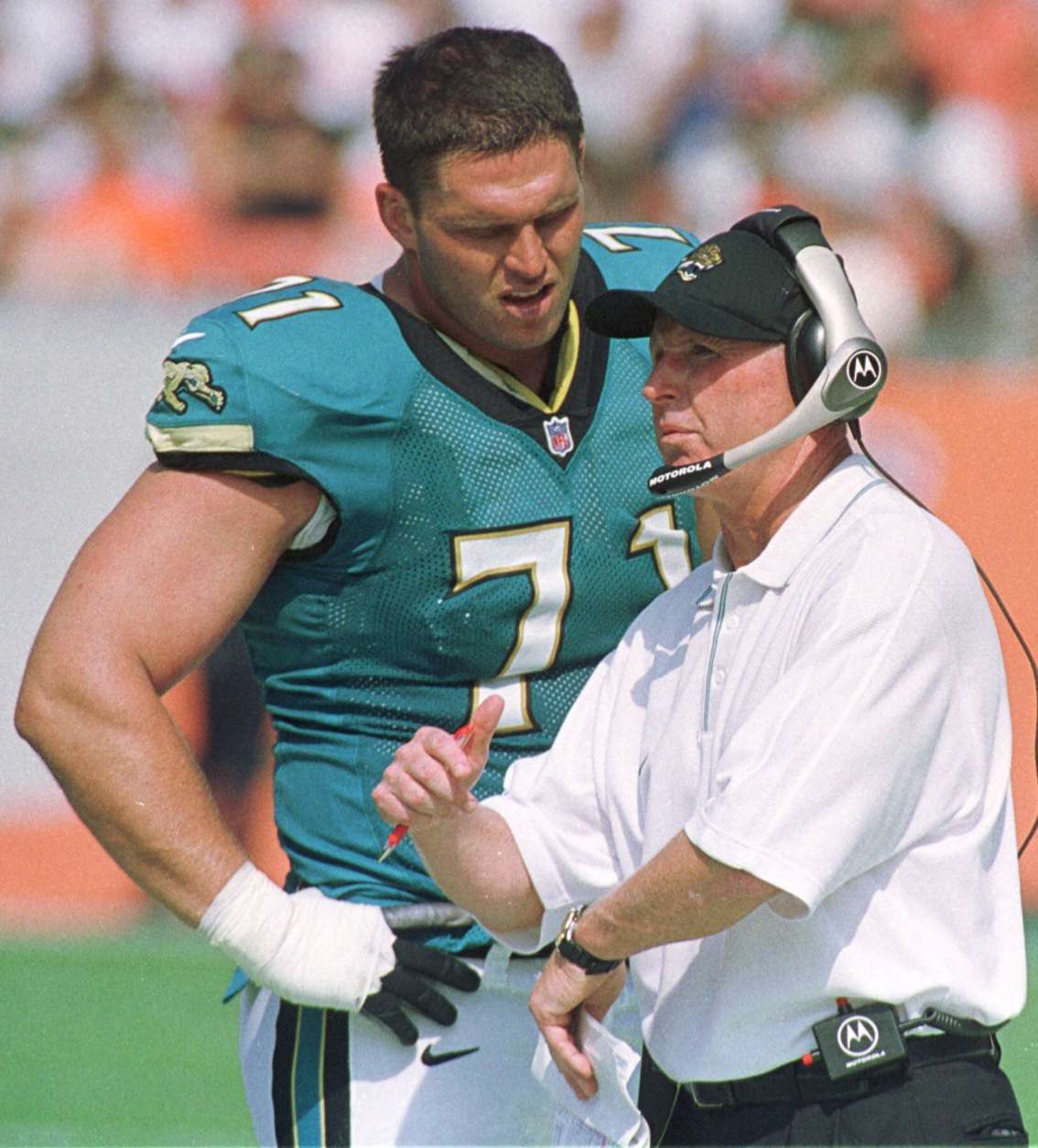 Jacksonville Jaguars tackle Tony Boselli (71) talks with coach Tom Coughlin on the sidelines during the Jaguars' 27-7 win over the Cleveland Browns in Cleveland, Sunday, Sept. 3, 2000. (AP Photo/Phil Long)
