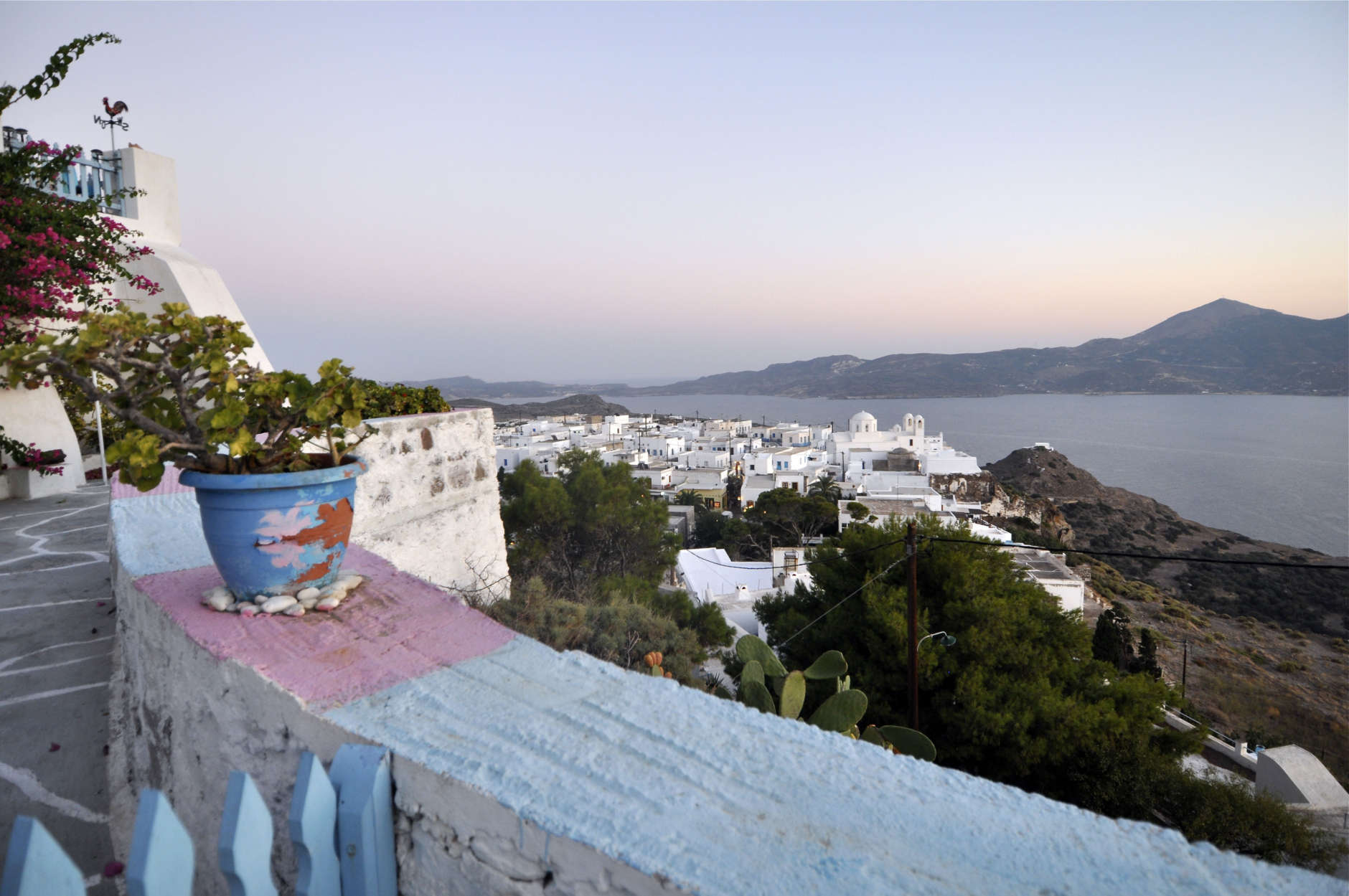 This August 2010 photo shows shows sunset on the hilltop village of Plaka on the Greek island of Milos. Milos is a perfect beach destination with an unusual feature: an array of colorful sandbelts, running from cream to black, with pebbles of nearly every color. (AP Photo/Marc Levy)