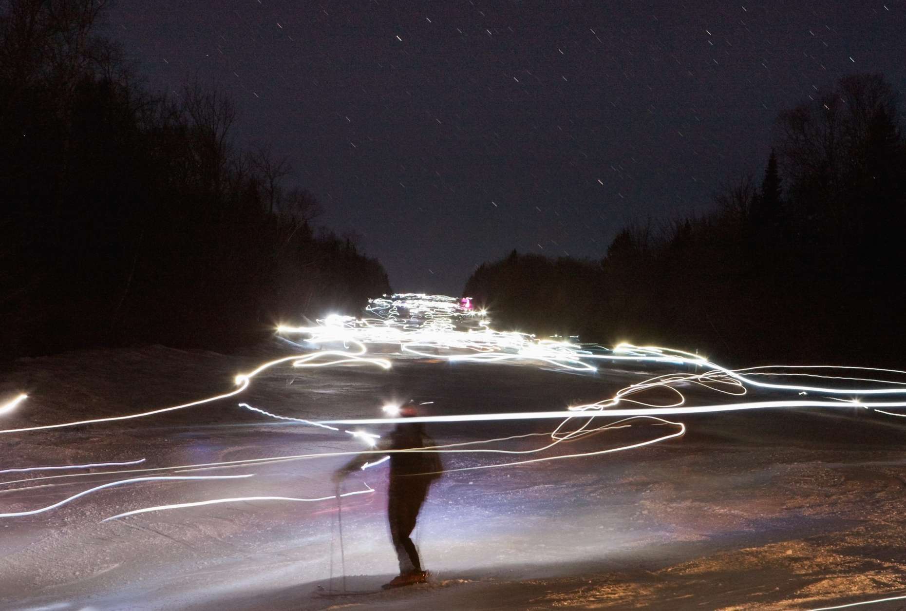 This photo taken using a long exposure shows skiers as they ski downhill wearing head lights during a night event, Wednesday Dec. 29, 2010, at Le Massif de Charlevoix in Petite-Riviere-Saint-Francois, Quebec. (AP Photo/The Canadian Press, Jacques Boissinot)