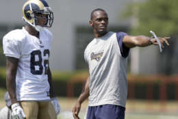 Former St. Louis Rams wide receiver Isaac Bruce, right, works with Rams wide receiver Greg Mathews during NFL football training camp Monday, Aug. 1, 2011, at the team's training facility in St. Louis. (AP Photo/Jeff Roberson)