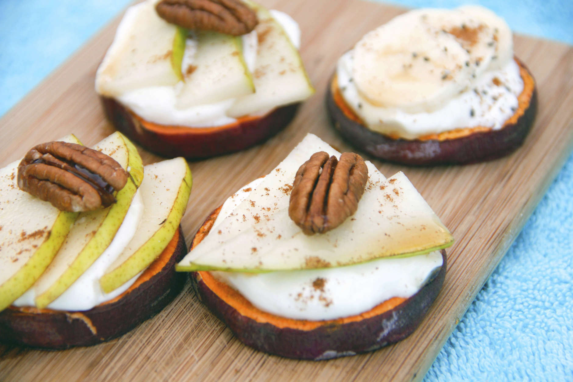 This Nov. 22, 2016 photo shows a recipe for sweet potato toasts made with slices of sweet potato, covered with pear and yogurt and topped with a pecan in Coronado, Calif. ( Melissa d'Arabian via AP)
