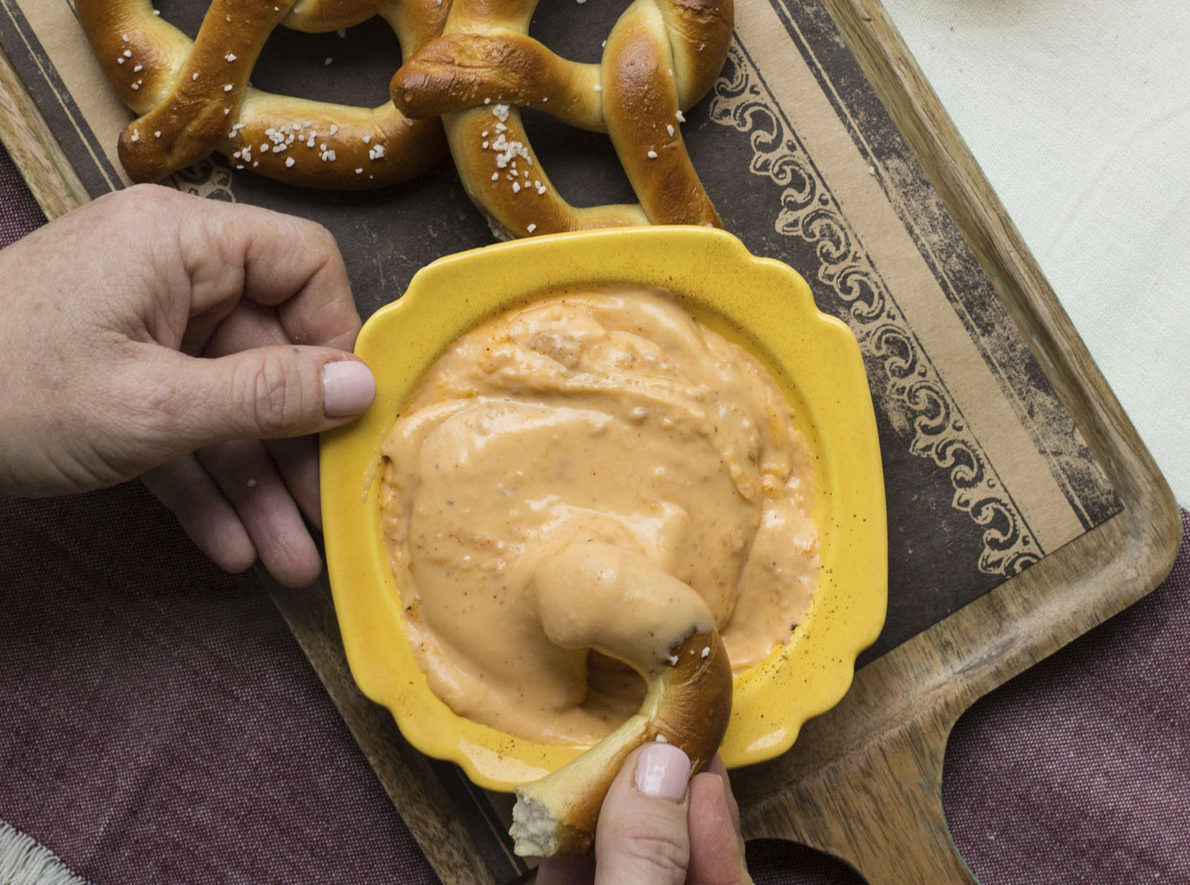This November 2016 photo shows soft pretzels with hot Cheddar cheese beer dip in New York. This dish is from a recipe by Katie Workman. (Sarah Crowder via AP)