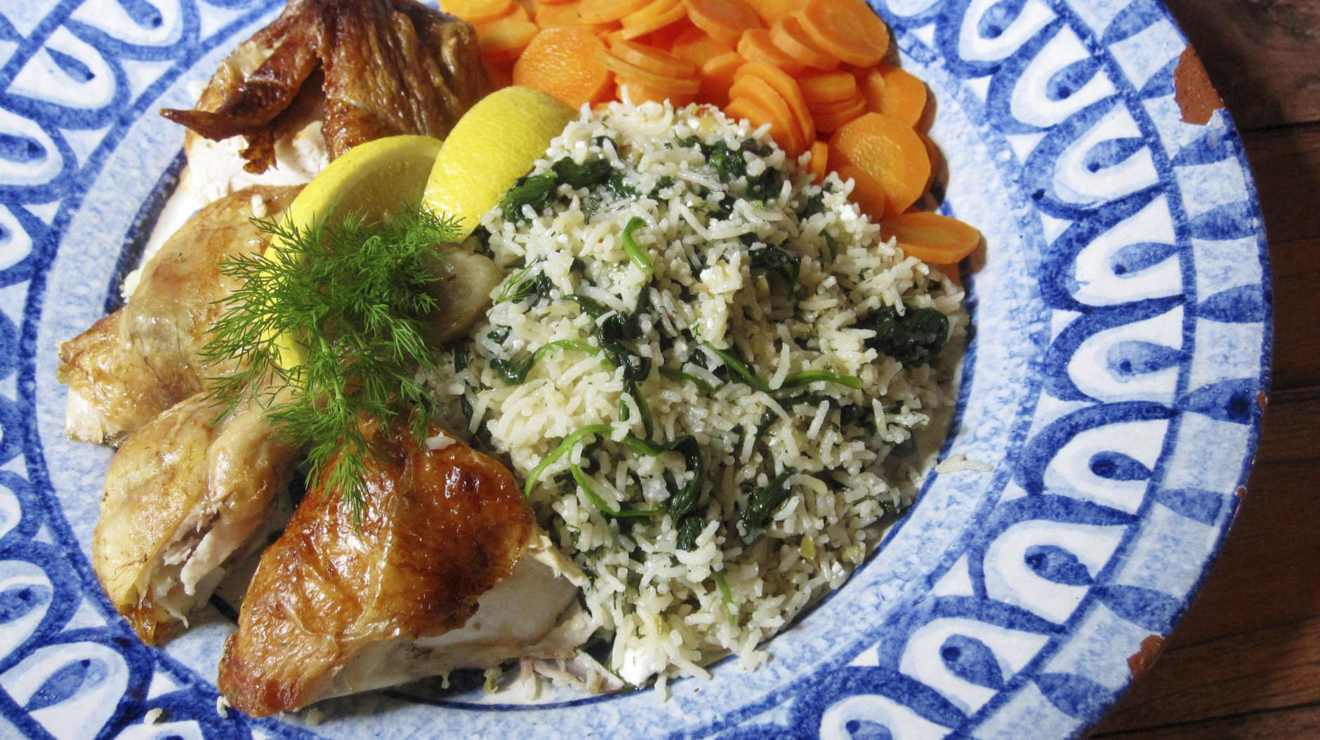 This photo shows a Greek-style rice pilaf served with chicken in New York. This dish is from a recipe by Sara Moulton. (Sara Moulton via AP)