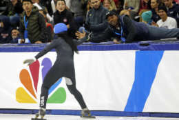 Maame Biney (1) celebrates with her coach after winning the women's 500-meter final A during the U.S .Olympic short track speedskating trials Saturday, Dec. 16, 2017, in Kearns, Utah. (AP Photo/Rick Bowmer)