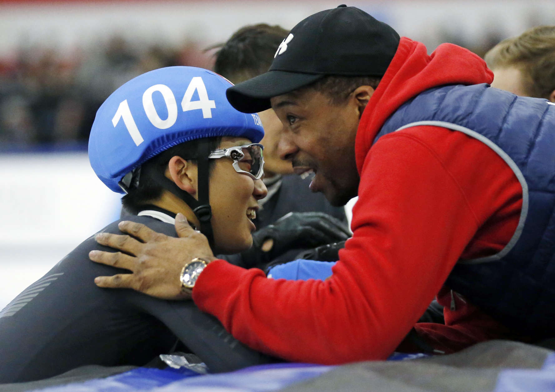 Thomas Insuk Hong (104) is congratulated by head coach Anthony Barthell after earning a nomination to the U.S.Olympic team after competing in the men's 1000-meter race during the U.S.Olympic short track speedskating trials Sunday, Dec. 17, 2017, in Kearns, Utah. (AP Photo/Rick Bowmer)