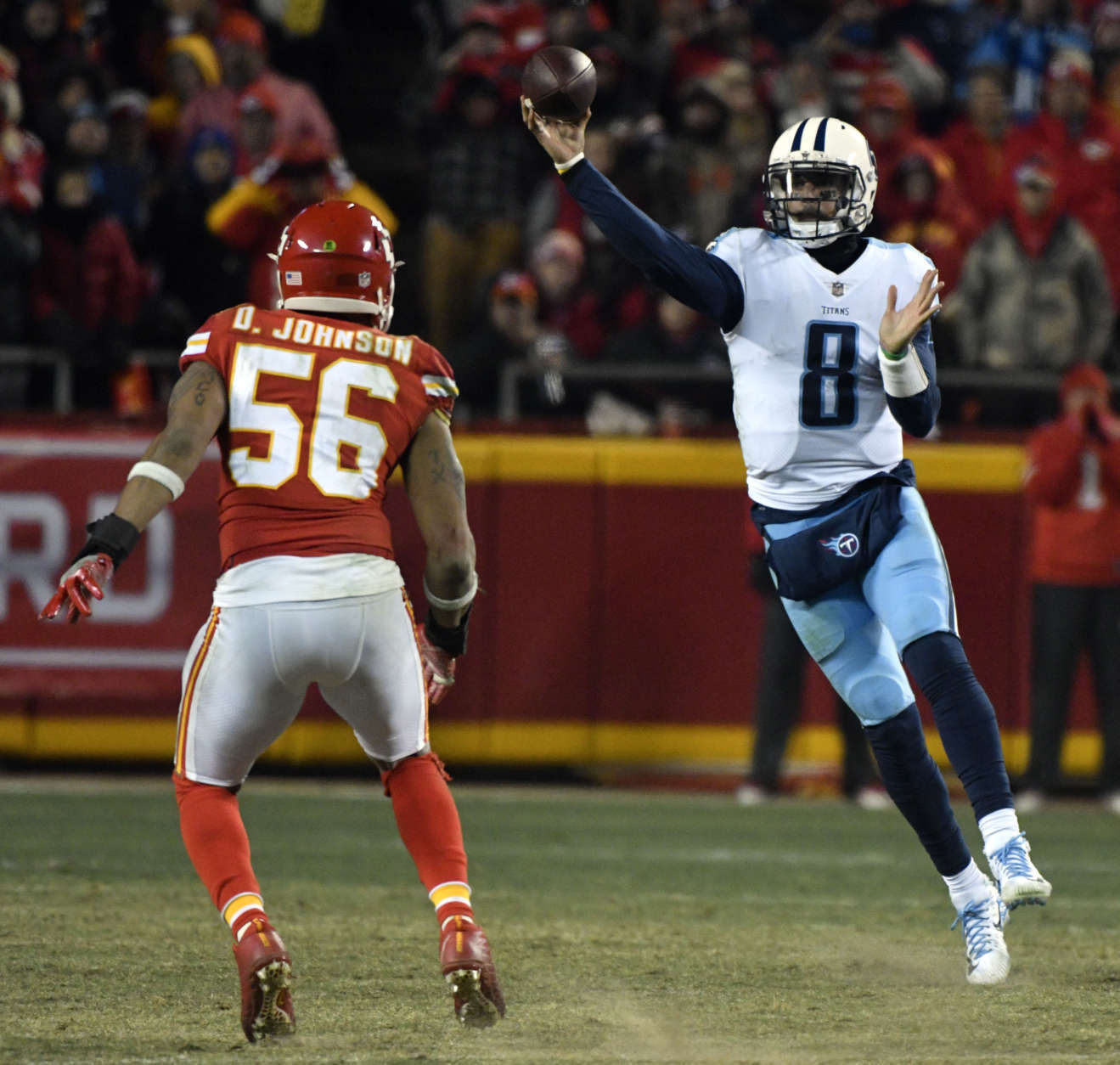 Tennessee Titans quarterback Marcus Mariota (8) throws in front of Kansas City Chiefs linebacker Derrick Johnson (56) during the second half of an NFL wild-card playoff football game, in Kansas City, Mo., Saturday, Jan. 6, 2018. (AP Photo/Ed Zurga)