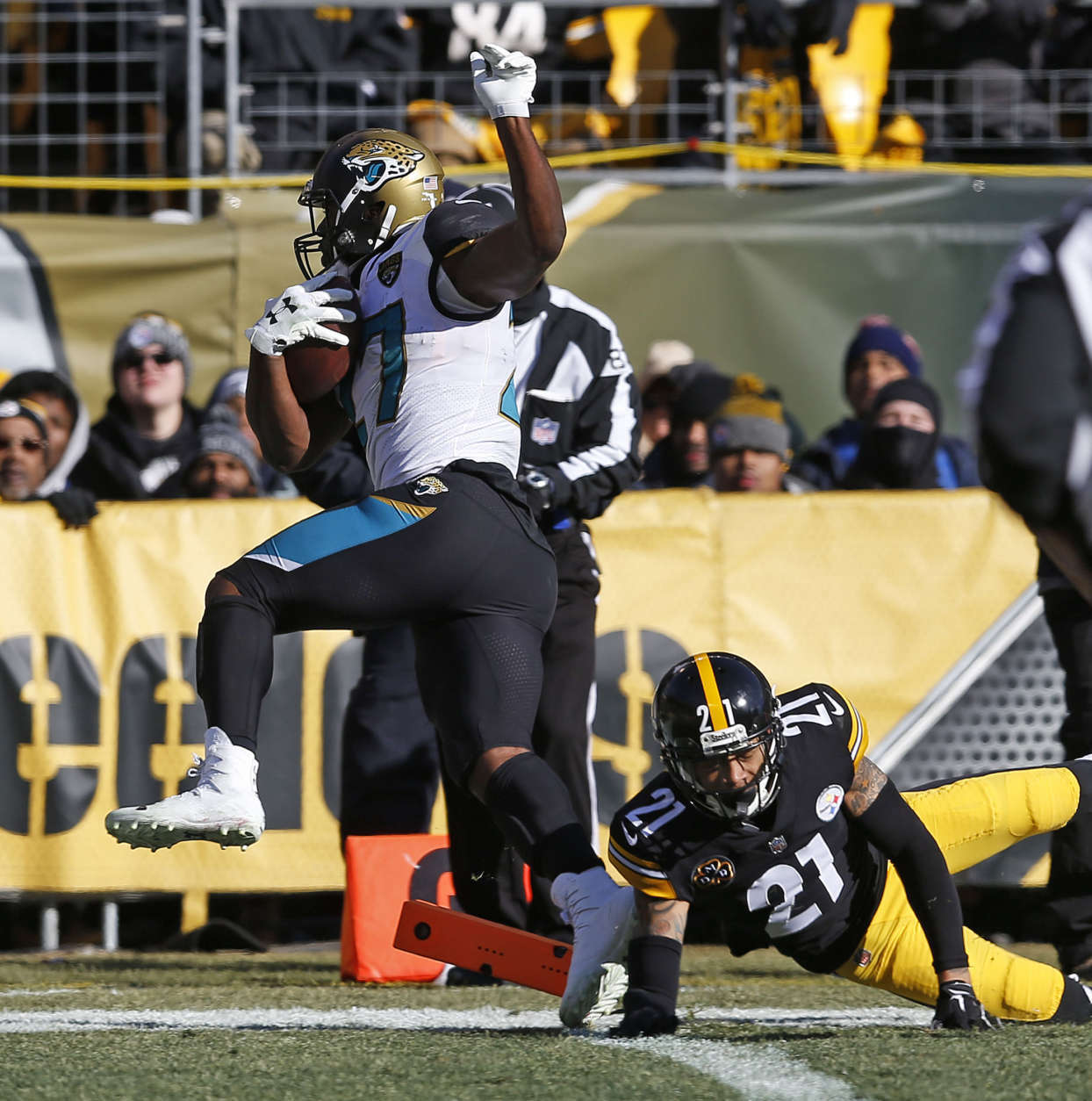 Jacksonville Jaguars running back Leonard Fournette (27) makes it into the end zone for a touchdown with Pittsburgh Steelers cornerback Joe Haden (21) defending during the first half of an NFL divisional football AFC playoff game in Pittsburgh, Sunday, Jan. 14, 2018. (AP Photo/Keith Srakocic)